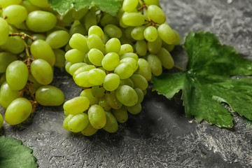 Fresh ripe juicy grapes on grey table