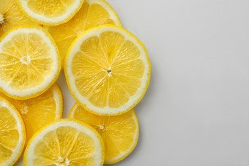 Fototapeta na wymiar Slices of ripe lemon on white background