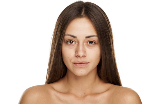Portrait of young beautiful woman with no makeup on white backgeound