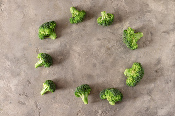 Frame made of fresh broccoli on grey background