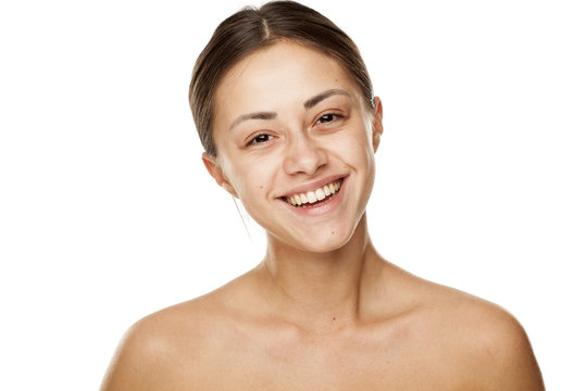 Portrait of young beautiful happy woman with no makeup on white backgeound