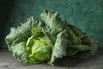 Fresh savoy cabbage on grey table