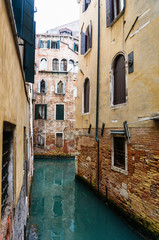 Fototapeta na wymiar Narrow Venetian canal - Venice, Italy