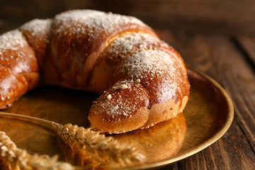Tasty fresh crescent roll on metal tray, closeup