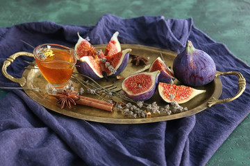 Fresh ripe figs with honey on metal tray