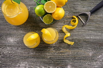 Flat lay composition with fresh lemon juice on wooden table