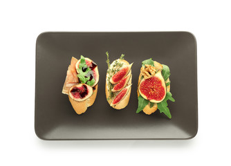 Tasty sandwiches with ripe fig on white background