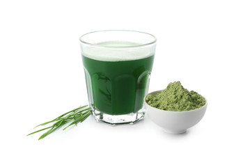 Glass of fresh wheat grass juice and bowl with powder on white background