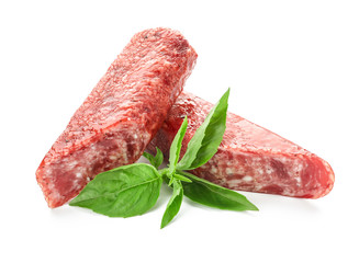 Delicious smoked sausages with basil on white background