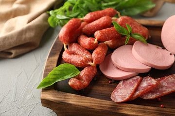 Different kinds of sausages on wooden board