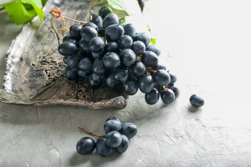 Plate with ripe sweet grapes on table