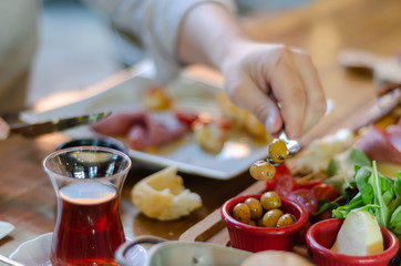 The man is eating breakfast in the restaurant.