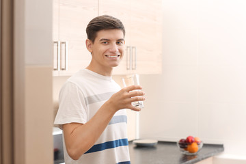 Fototapeta premium Young man with glass of water at home