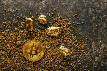 Bitcoin and gold nuggets on grey background