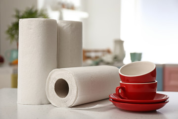 Rolls of paper towels with dishware on kitchen table
