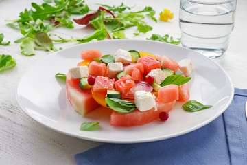 Plate with delicious watermelon salad on white table