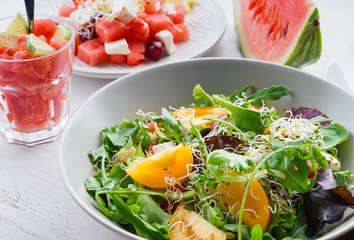 Plate with delicious watermelon salad on white table