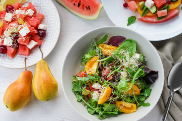 Plates with delicious watermelon salads on white table