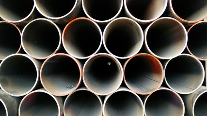 Steel pipes profile stack. New square metal pipes in stock. Stack of steel, Steel material. Steel...