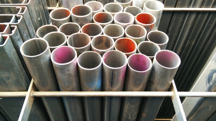Steel pipes profile stack. New square metal pipes in stock. Stack of steel, Steel material. Steel...