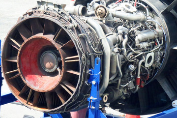 Fototapeta premium Airplane gas turbine engine detail in aviation hangar. Plane rotor under heavy maintenance.