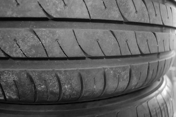 Close-up view of the tires. Background with rubber tyres for the car. Auto theme. 