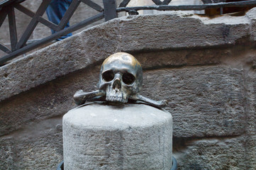 bronze skull outside a historic church, Naples