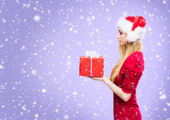 Portrait of attractive blond woman over Christmas background with snow.