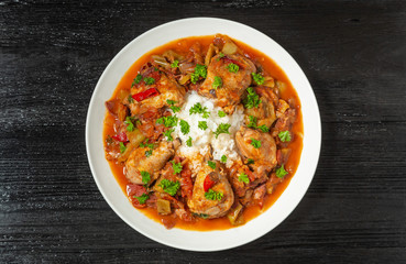 Chicken chilindron with thick vegetable sauce with red wine and dry-cured ham. The view from the top. Copy-space.