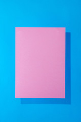 Pink paper on a blue background for decoration, for text design, for a template