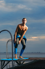Male athlete wearing a thermal swimsuit. the man wears a wetsuit