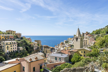 Fototapeta na wymiar View of the seaside village of Riomaggiore and the Church of San Giovanni Battista, Cinque Terre, Liguria, Italy