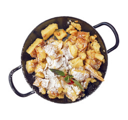 Kaiserschmarrn sugared in black iron pan isolated on white