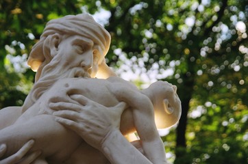 Summer garden in Saint Petersburg with sculpture of Uran eating his child © Er