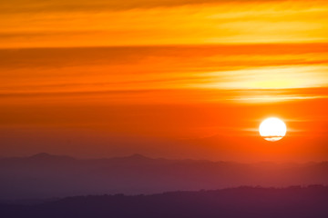 Dramatic sunset and sunrise over mountain morning evening sky.