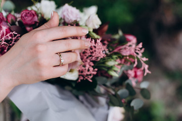 Fototapeta premium Hand arranged girl. Bouquet of red and white flowers