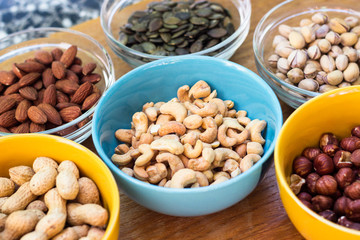 Assortment of mixed nuts on wood table background 