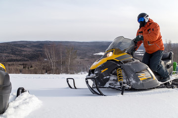 Fototapeta na wymiar Athlete on a snowmobile