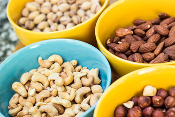 Assortment of mixed nuts on wood table background 