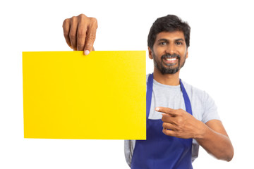 Supermarket employee presenting yellow paper.