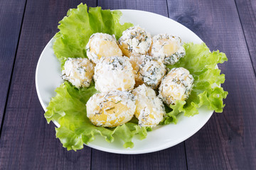Boiled potatoes with sour cream on a plate