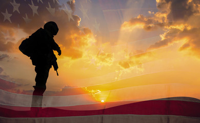 Double exposure Silhouette of Soldier on the United States flag in sunset for Veterans Day is an...