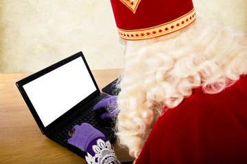 Sinterklaas with notebook or laptop