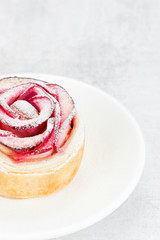 Beautiful apple rose cake coated with powdered sugar