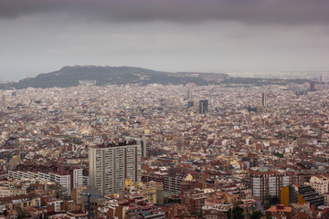 Cloudy view on Barcelona city from the mountain