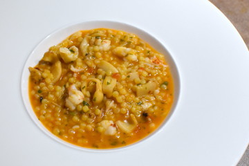 Sardinian fregola with fresh shrimp and cuttlefish, italian food specialties