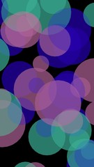 Multicolored translucent circles on a dark background. Vertical image orientation. 3D illustration