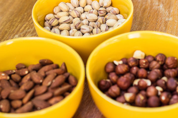Assortment of mixed nuts on wood table background 