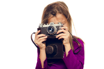 girl with a retro camera takes pictures on a white background