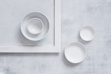 Light abstract composition with empty white plates